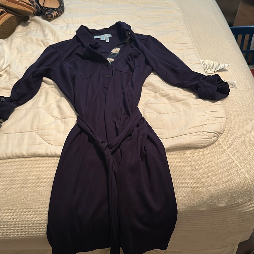 Navy dress with floral accent and folded sleeves